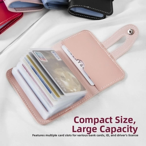 Detail view of the pink faux leather card holder with 26 slots and clear PVC pockets