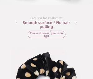 Close-up of black velvet scrunchie with beige polka dots and soft texture detail