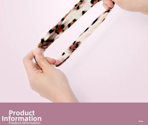 Detail showing high elasticity of leopard print scrunchie with soft fabric texture