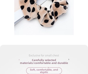 Detailed shot of beige polka dot scrunchie made from soft fabric with elastic band