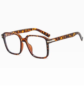 Detail of tortoise shell square frames with silver metal hinge accents on temple