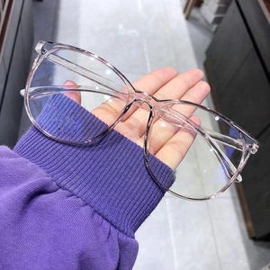 Detailed close-up of large-frame blue light blocking glasses in transparent light pink