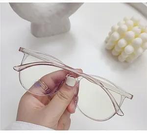 Close-up of translucent pink oversized round anti-blue light glasses with functional lens label