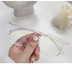 Detail of transparent oversized anti-blue light glasses held in a hand for modern lifestyle