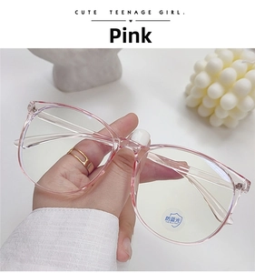 Close-up of pink round oversized anti-blue light glasses frame with functional lens sticker