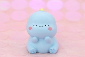 Macro shot of a cute blue dinosaur figurine for cake decoration and birthday gifts