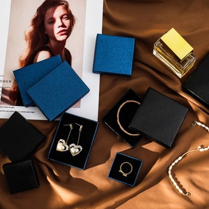Elegant black and blue textured jewelry gift boxes on silk for rings and necklaces