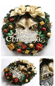 Close-up of golden bells and red bows on a 30cm Christmas wreath with Merry Christmas sign