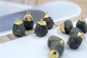 Macro detail of natural faceted Labradorite pendants with gold plated metal bails
