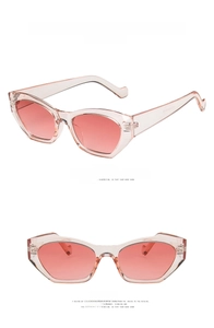 Detail view of transparent pink cat eye sunglasses showing temple engraving and side profile