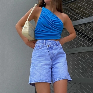 Women's blue one-shoulder cropped top with pleated design and light blue denim shorts