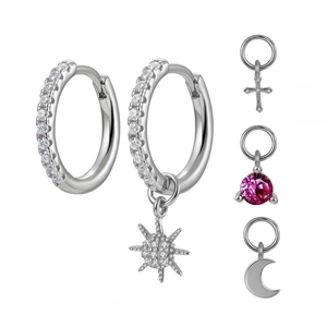 Detailed view of silver hoop earrings with interchangeable moon, star, and cross charms