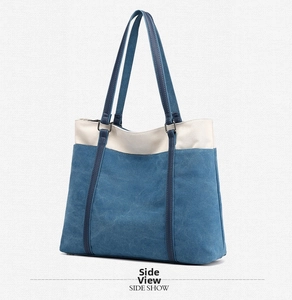 Detail view of large canvas tote bag with blue and white contrast and metal buckle