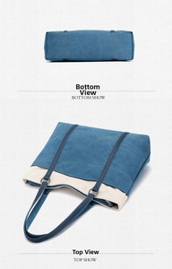 Detailed bottom and flat lay view of a navy blue and beige canvas tote with metal rings