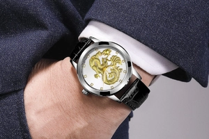 Close-up of luxury gold dragon relief on white dial with black crocodile leather strap