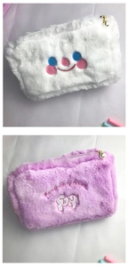 Detail of plush makeup bags with smiley face and lamb embroidery plus pearl pendants