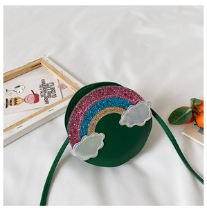 Detail view of a green round crossbody bag for girls with sequined rainbow and clouds