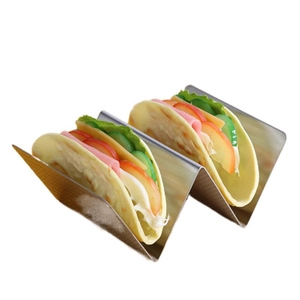 Polished stainless steel taco holder with W-shape design on clean white background