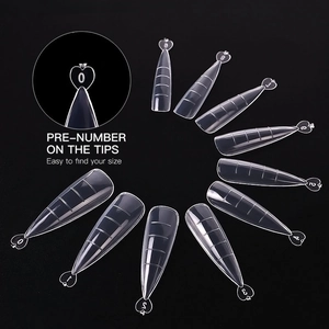 Clear acrylic nail extension tips showing size markings and heart-shaped handles