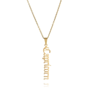 Macro shot of Capricorn zodiac pendant in gold stainless steel with gothic font detail