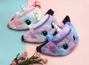 Detailed macro view of plush unicorn waist bags in gradient pink, purple and blue shades