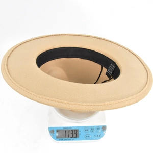 Detail shot of camel wide brim felt fedora hat on electronic scale weighing 113.9g