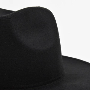 Macro shot of fine black felt texture on wide brim wool jazz hat with elegant details