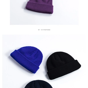 Detailed view of cuffed ribbed knit beanies in multiple colors on a clean white background