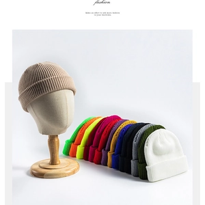 Close-up of ribbed knit beanies in various colors including beige, orange and blue