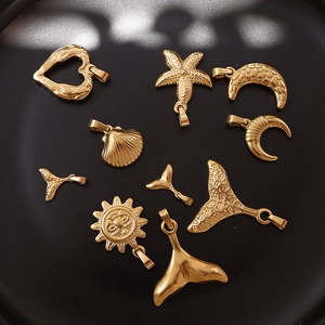 Golden 18K gold plated moon and starfish ocean pendants on a professional black background