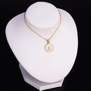 Golden stainless steel necklace featuring a round pendant with the letter A on a white base