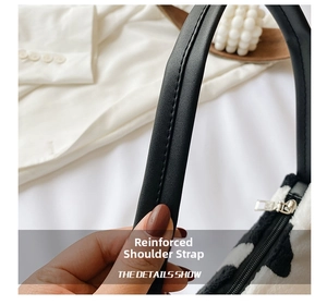 Detail showing the reinforced black PU leather shoulder strap with visible stitching