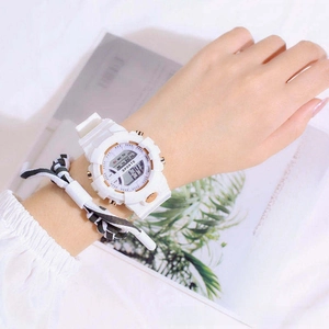 Close-up of white digital sports watch with silicone strap and multi-function display