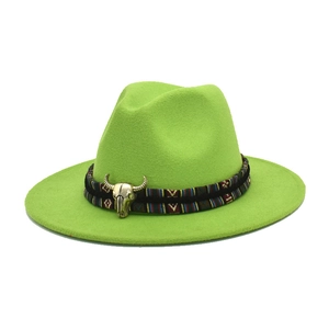 Detail view of the bright green wool fedora with ethnic woven band and bull skull pendant