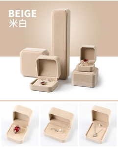 Macro view of beige velvet jewelry boxes for rings, necklaces and pendants