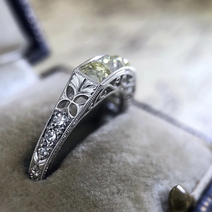 Detailed macro view of vintage silver ring with yellow zircon in a velvet jewelry box