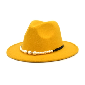 Detail of yellow wool fedora hat with black ribbon and elegant pearl embellishments