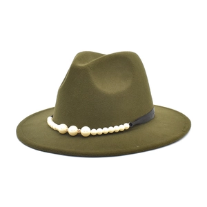 Detail of olive green fedora hat featuring a pearl beaded band with gold accents