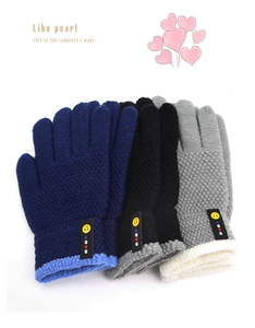 Detail of knitted kids gloves with smiley face baby tag and contrast ribbed cuffs