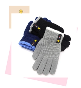 Three-pack of knitted kids gloves in black, grey, and navy with yellow smiley face patches