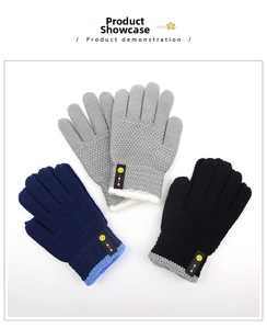 Detailed view of knitted winter gloves for children in black, navy blue and grey colors