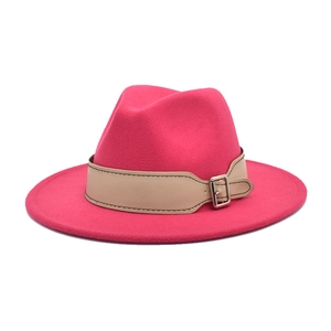 Detail of bright pink wool fedora with beige leather band and silver metal buckle