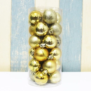 Cylindrical pack of gold Christmas ornaments in shiny, matte, and glitter finishes