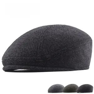 Close-up of herringbone pattern wool flat cap with multiple color options displayed