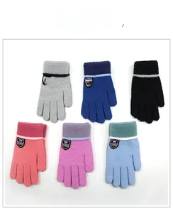 Detail showing colorful knitted gloves set with classic shield patch and striped cuffs