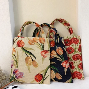 Close-up of vintage tulip jacquard weave texture on retro floral handbag fabric