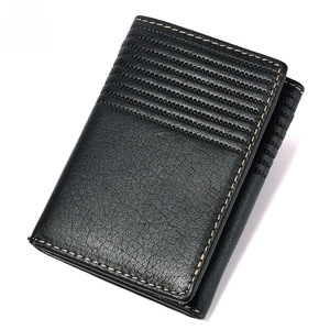 Detail of RFID blocking black leather wallet with textured surface and durable stitching