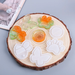 Macro detail of silicone shaker molds for DIY resin pendants in animal and floral shapes