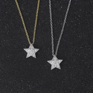 Detailed view of gold and silver star necklaces with sparkling pavé cubic zirconia