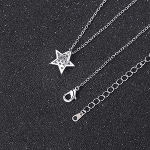 Minimalist silver star pendant necklace featuring sparkling cubic zirconia on black backdrop